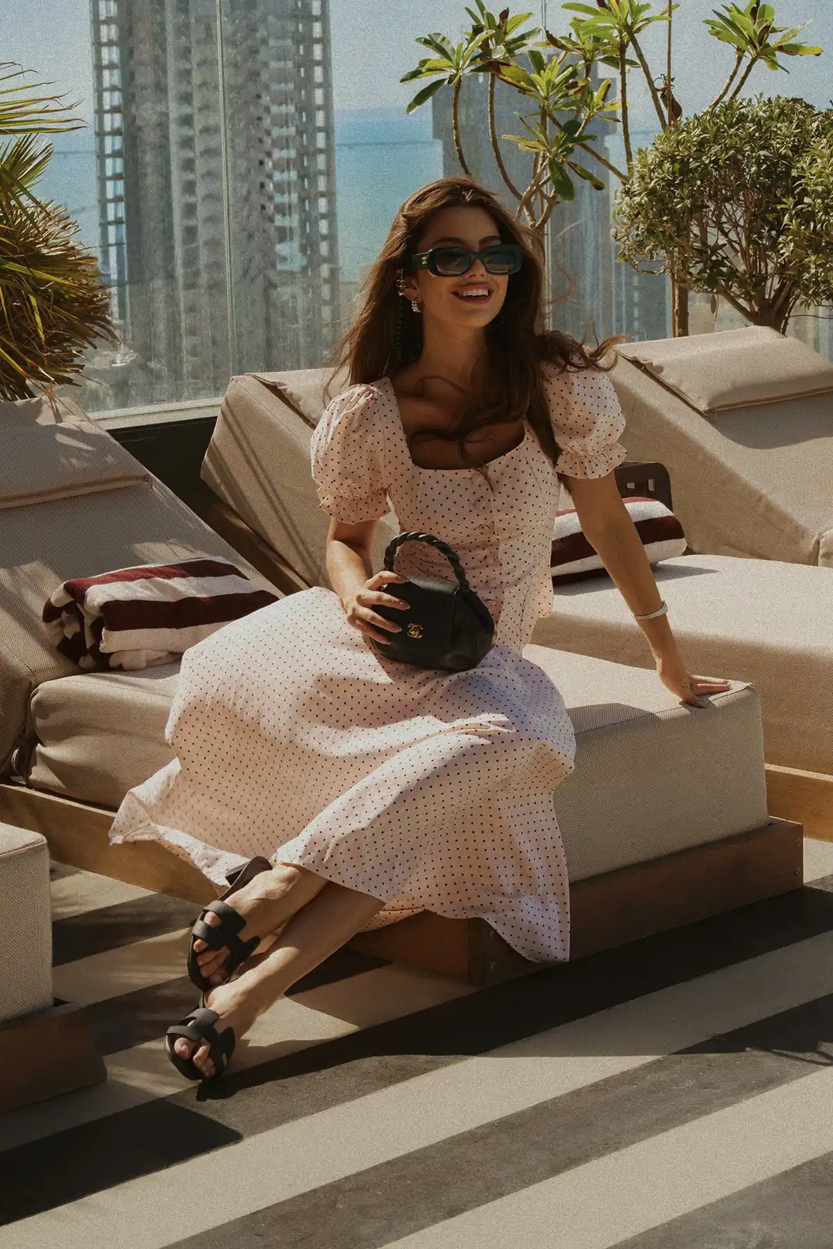 Guest relaxing by the rooftop pool
